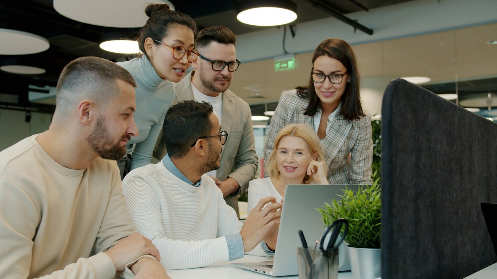 Team collaborating. Photo by Vitaly Gariev on Unsplash. Source: https://unsplash.com/photos/diverse-team-collaborating-around-a-laptop-in-office-yd_RKGH_RH4 (Unsplash License).