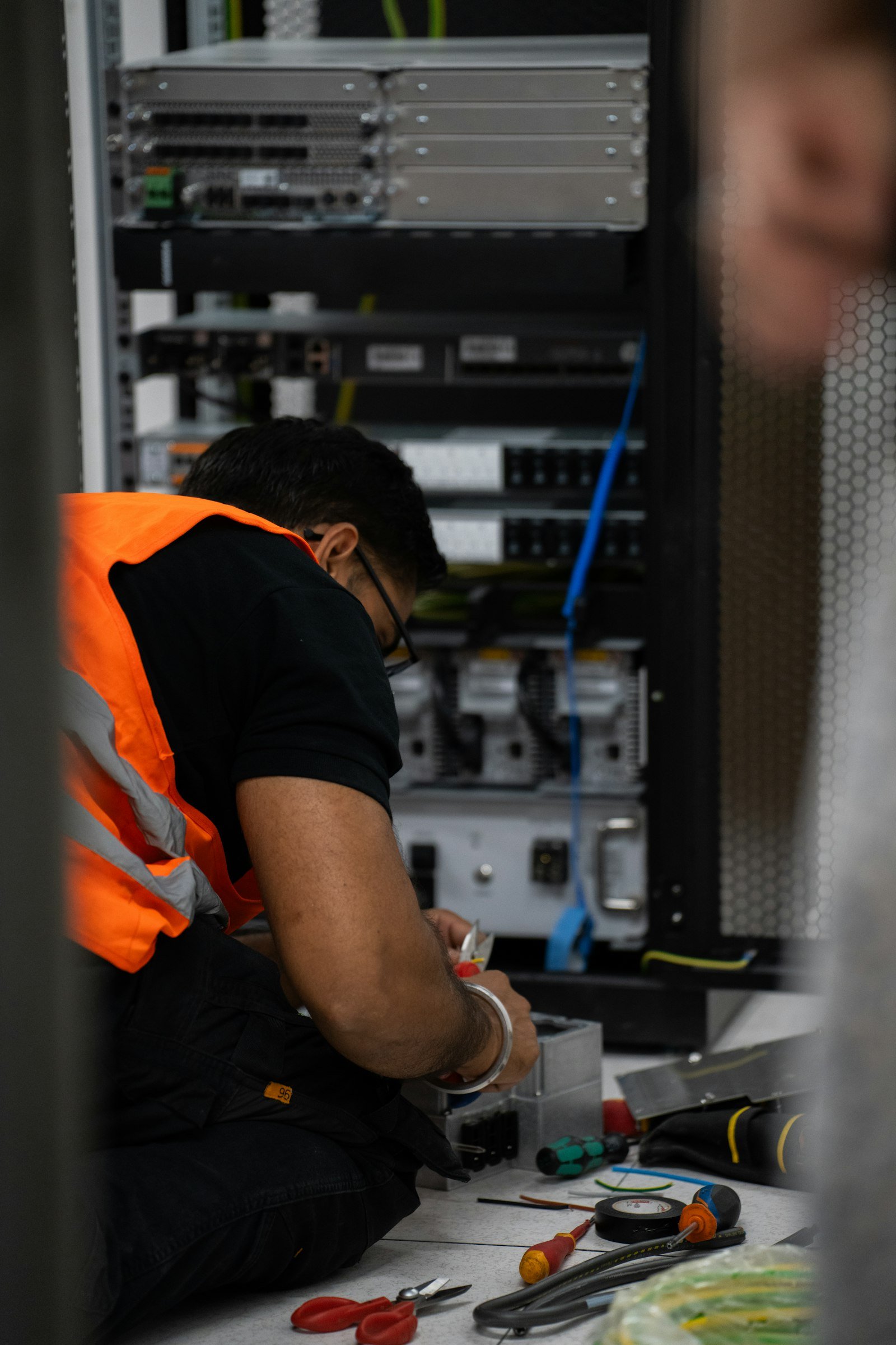 Valentin Lacoste. Photo by Valentin Lacoste on Unsplash. Source: https://unsplash.com/photos/technician-working-on-server-equipment-with-tools-ufT32_VFS-I (Unsplash License).