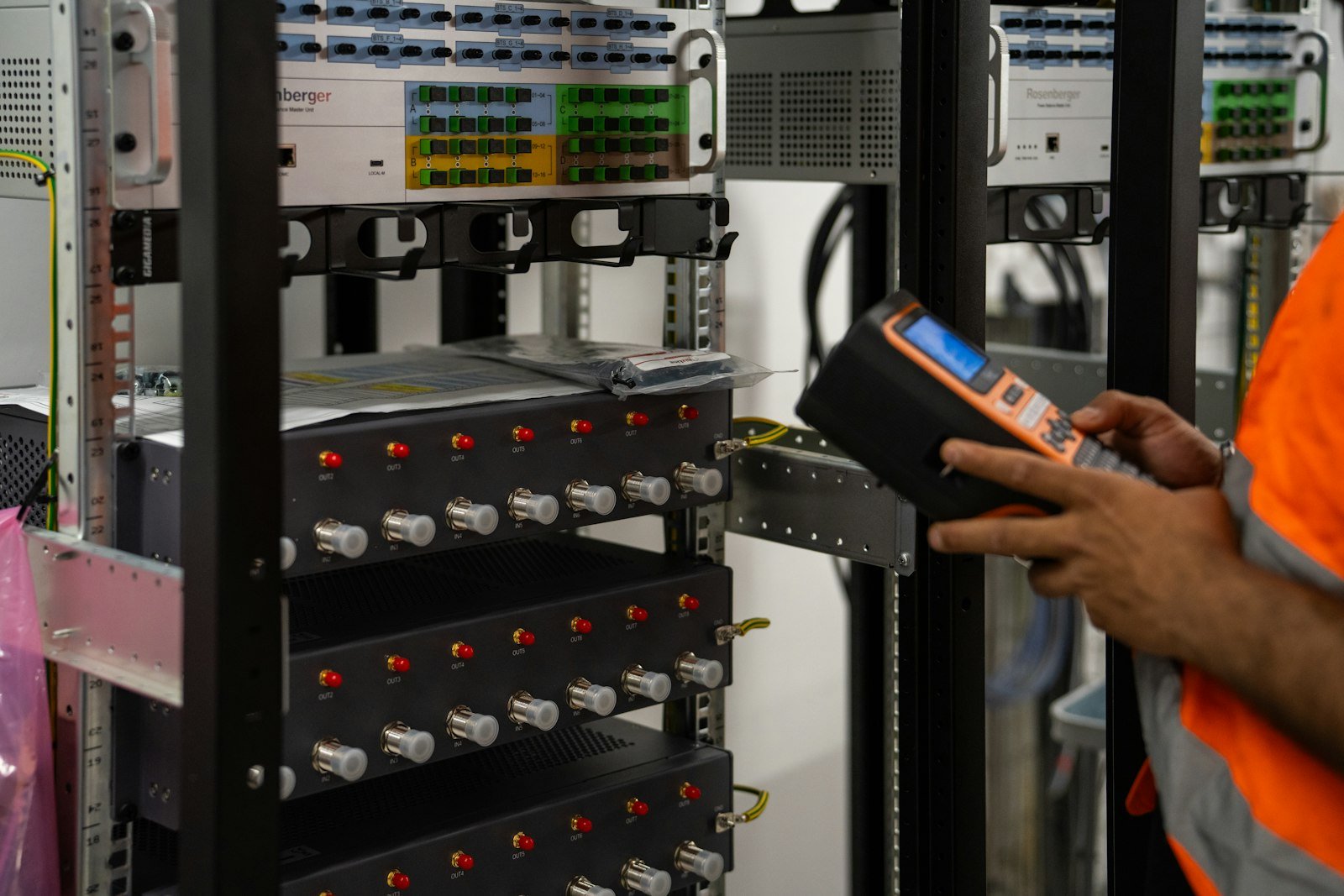 Valentin Lacoste. Photo by Valentin Lacoste on Unsplash. Source: https://unsplash.com/photos/technician-inspecting-server-racks-with-a-handheld-diagnostic-tool-A-b2nPSSK6E (Unsplash License).