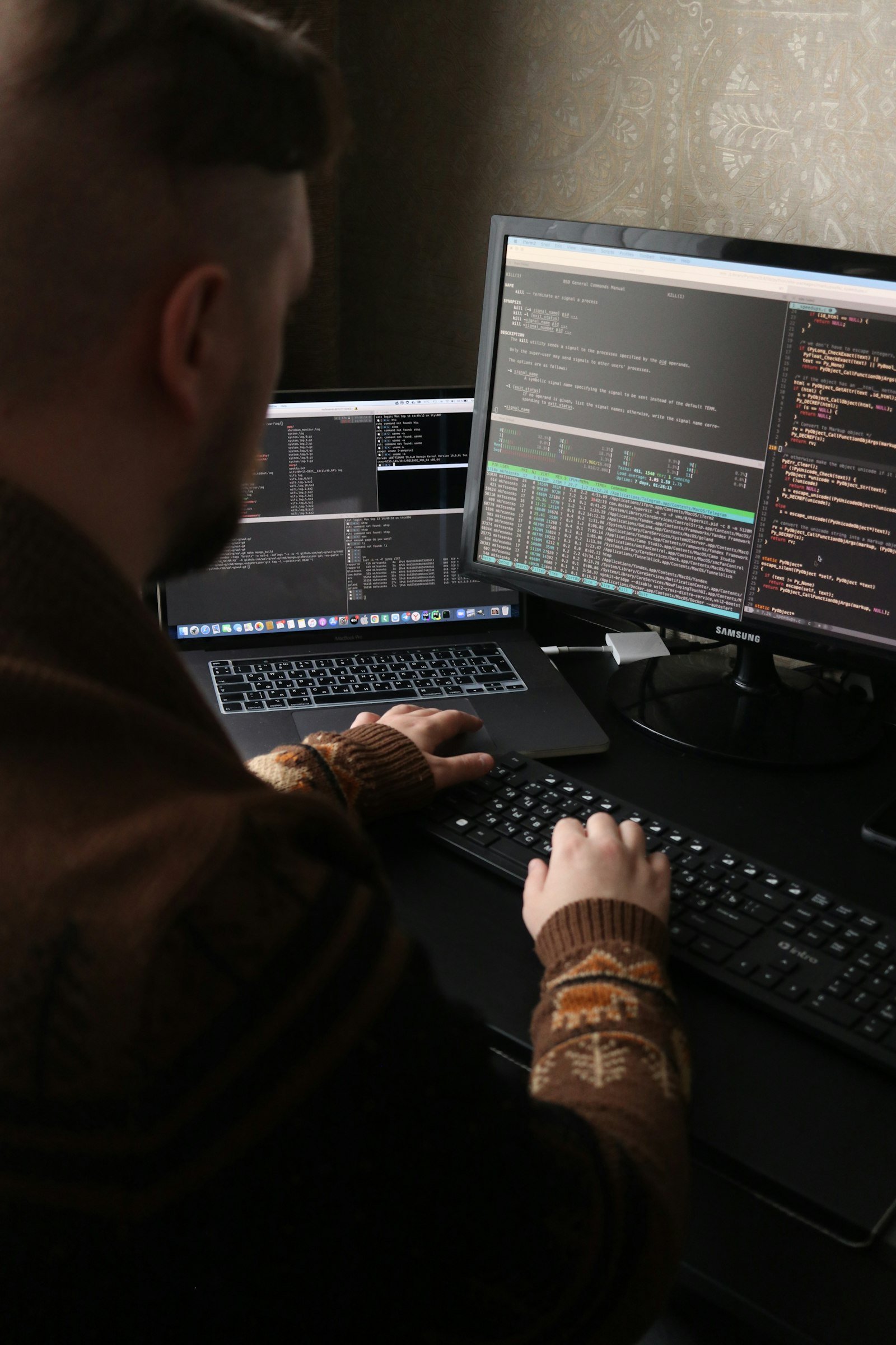 Mikhail Fesenko. Photo by Mikhail Fesenko on Unsplash. Source: https://unsplash.com/photos/a-man-sitting-in-front-of-a-computer-on-a-desk-KniBt27bEsc (Unsplash License).