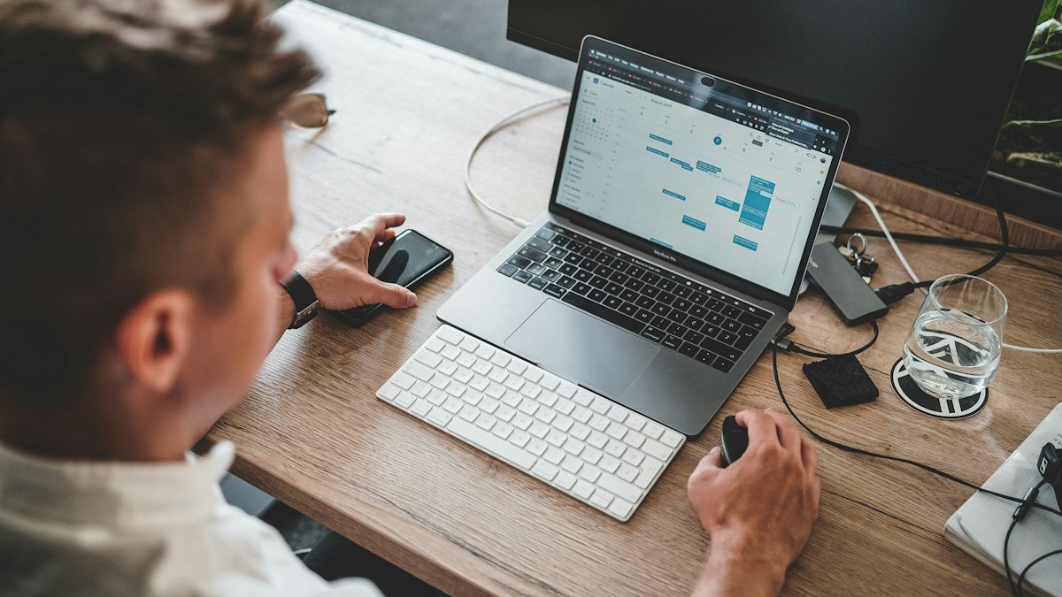 Photo by Zan Lazarevic on Unsplash. Source: https://unsplash.com/photos/man-holding-mouse-and-iphone-while-using-macbook-pro-AmEeEB1g3XQ (Unsplash License).