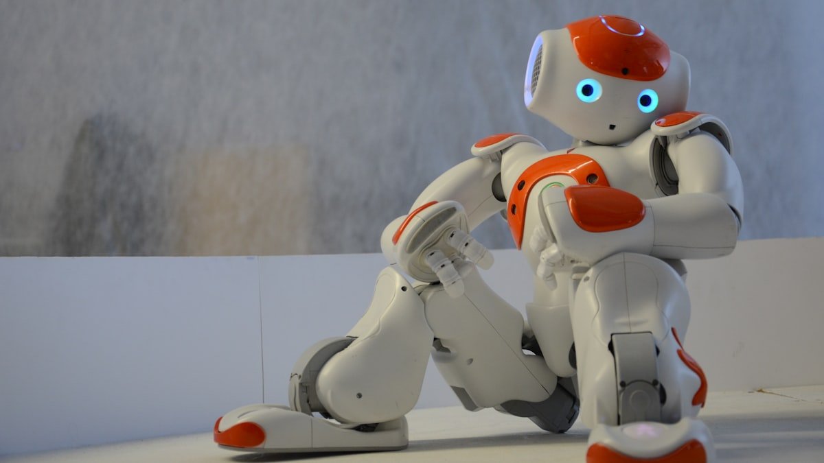 Photo by Erhan Astam on Unsplash. Source: https://unsplash.com/photos/white-and-orange-robot-near-wall-yLcK3Itx6ok (Unsplash License).