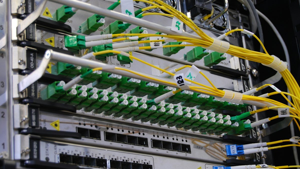 Photo by Kirill Sh on Unsplash. Source: https://unsplash.com/photos/fiber-optic-cables-in-network-switch-eVWWr6nmDf8 (Unsplash License).