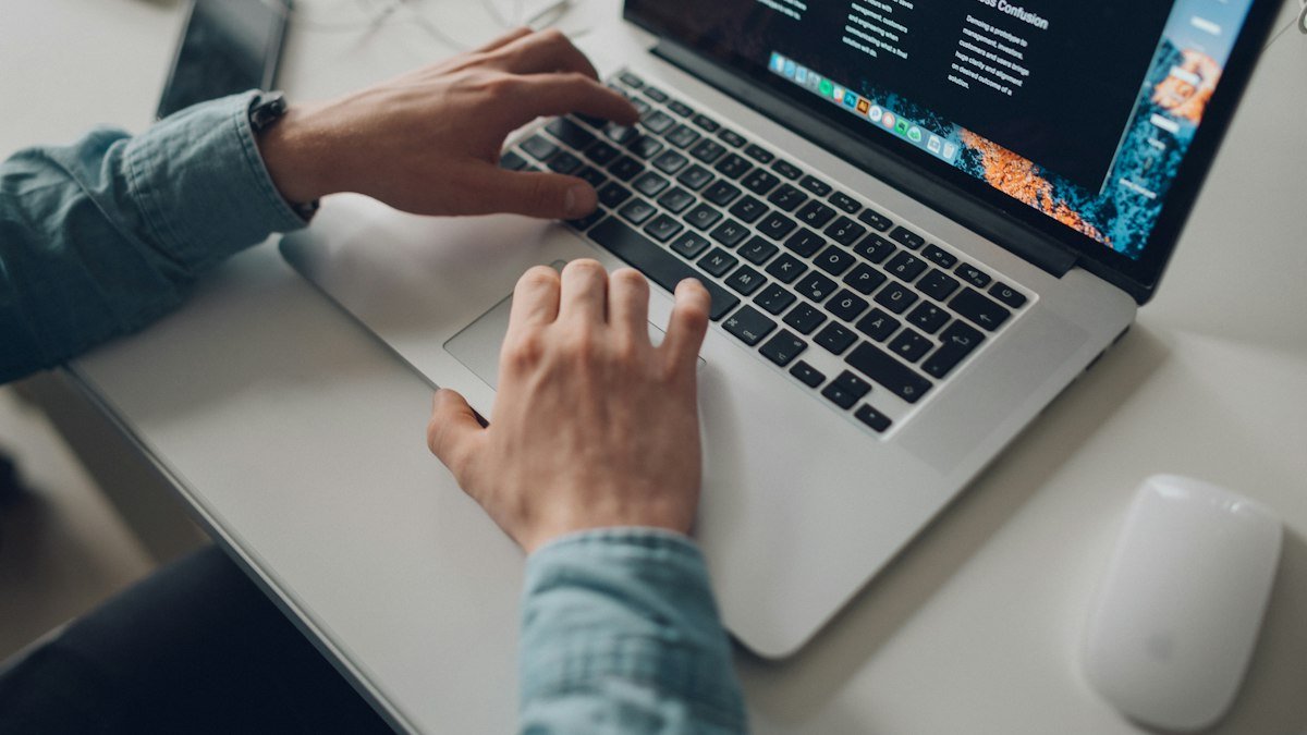 A person typing on a laptop computer. Photo by Štefan Štefančík on Unsplash. Source: https://unsplash.com/photos/person-wearing-long-sleeve-top-working-on-laptop-5p_7M5MP2Iw (Unsplash License).