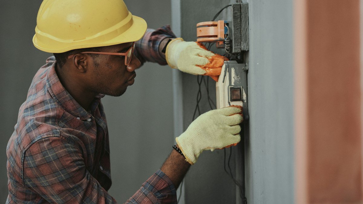 Photo by Emmanuel Ikwuegbu on Unsplash. Source: https://unsplash.com/photos/electrician-installing-wiring-with-yellow-hardhat-_2AlIm-F6pw (Unsplash License).