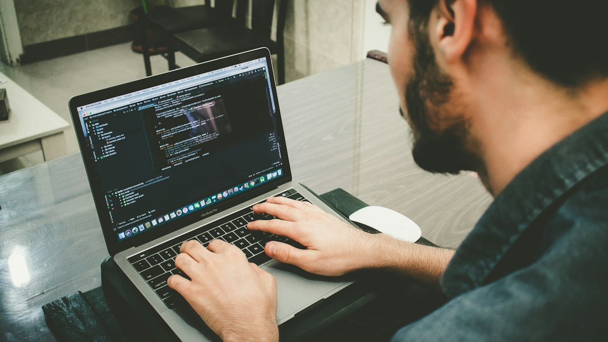 Photo by Danial Igdery on Unsplash. Source: https://unsplash.com/photos/man-programming-using-laptop-FCHlYvR5gJY (Unsplash License).