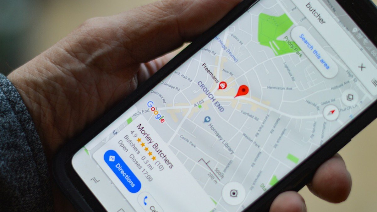 Photo by henry perks on Unsplash. Source: https://unsplash.com/photos/BJXAxQ1L7dI (Unsplash License). A person holding a smartphone showing a map with location pins.