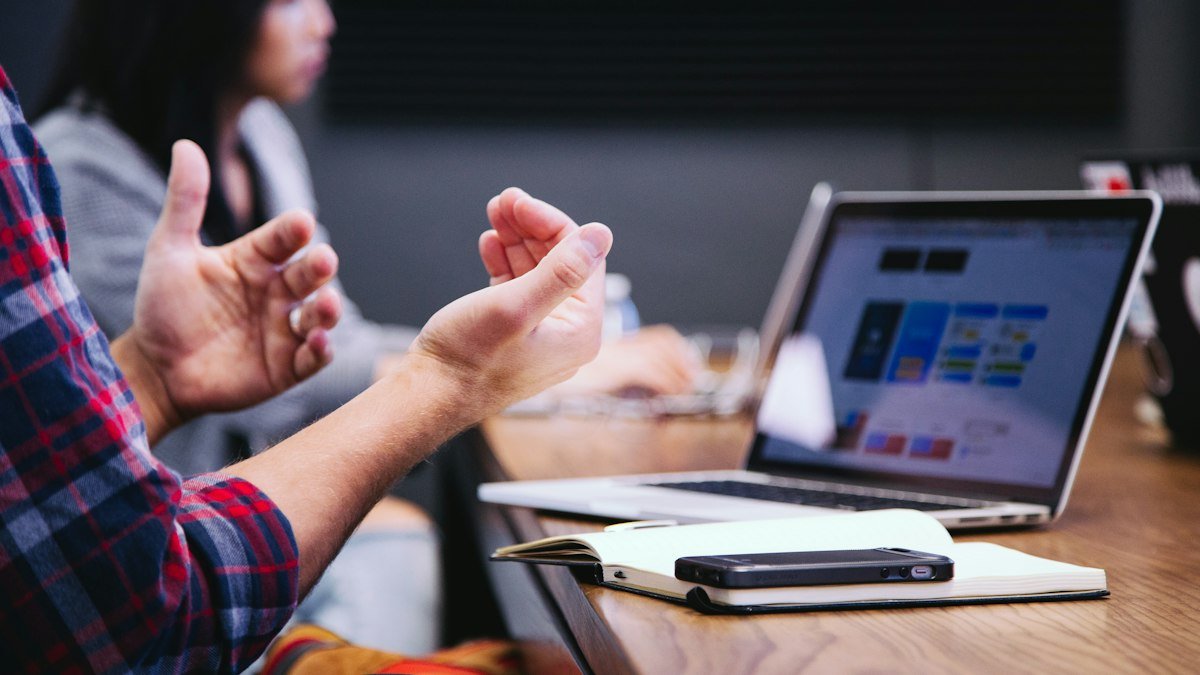 Photo by Headway on Unsplash. Source: https://unsplash.com/photos/person-gesturing-during-meeting-with-laptop-5QgIuuBxKwM (Unsplash License).