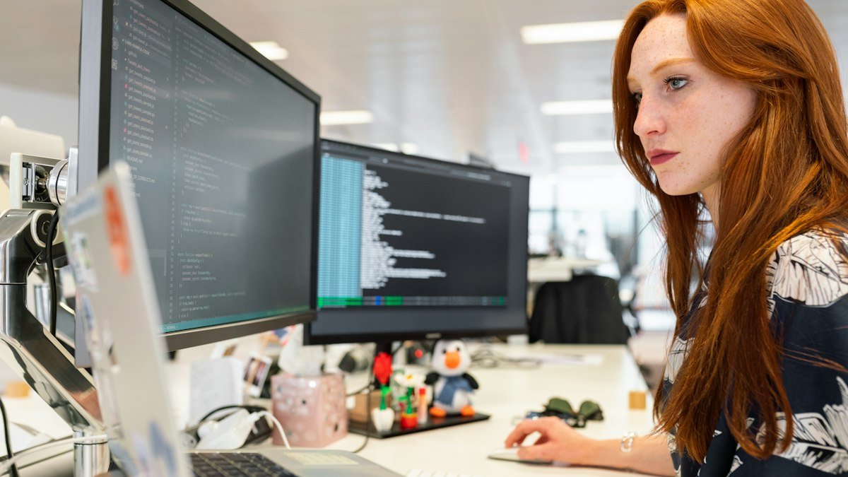 Photo by ThisisEngineering on Unsplash. Source: https://unsplash.com/photos/woman-in-green-shirt-sitting-in-front-of-computer-64YrPKiguAE (Unsplash License).