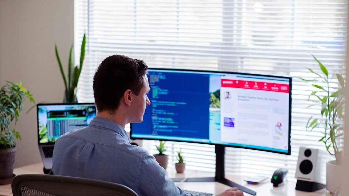 Photo by Luke Peters on Unsplash. Source: https://unsplash.com/photos/man-in-gray-dress-shirt-sitting-on-chair-in-front-of-computer-monitor-B6JINerWMz0 (Unsplash License).