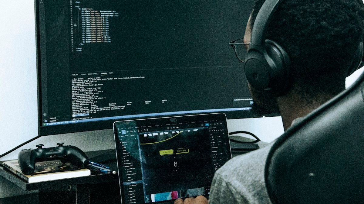 Photo by Olumuyiwa Sobowale on Unsplash. Source: https://unsplash.com/photos/a-man-sitting-in-front-of-a-computer-wearing-headphones-kQIdjLbCghA (Unsplash License).