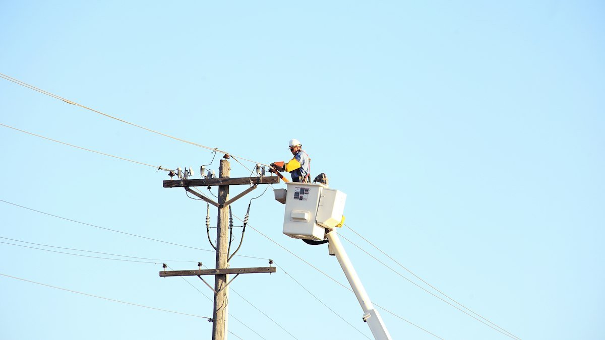 Photo by American Public Power Association on Unsplash. Source: https://unsplash.com/photos/man-standing-on-bucket-beside-gray-current-post-at-daytime-hp1-hMaMBrU (Unsplash License).