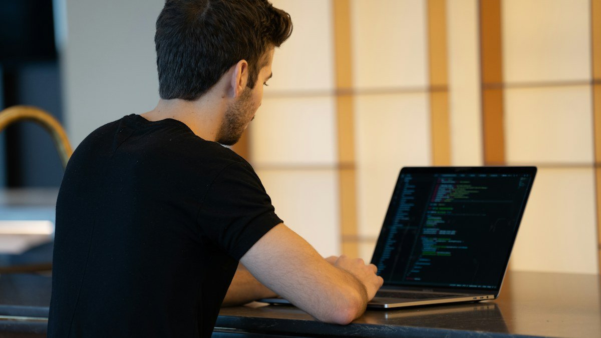 Photo by Anthony Riera on Unsplash. Source: https://unsplash.com/photos/man-in-black-t-shirt-using-laptop-computer--ZZ7I31c0B8 (Unsplash License).