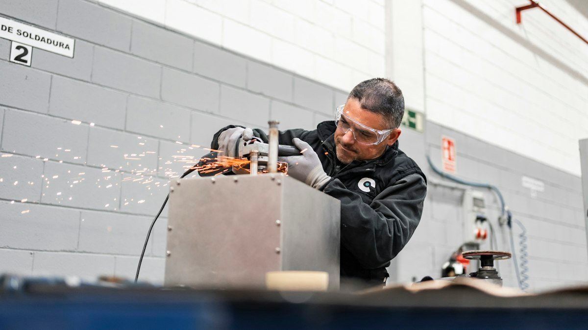 Photo by TECNIC Bioprocess Solutions on Unsplash. Source: https://unsplash.com/photos/a-worker-uses-a-grinder-creating-sparks-9IEGO2zcM2s (Unsplash License).
