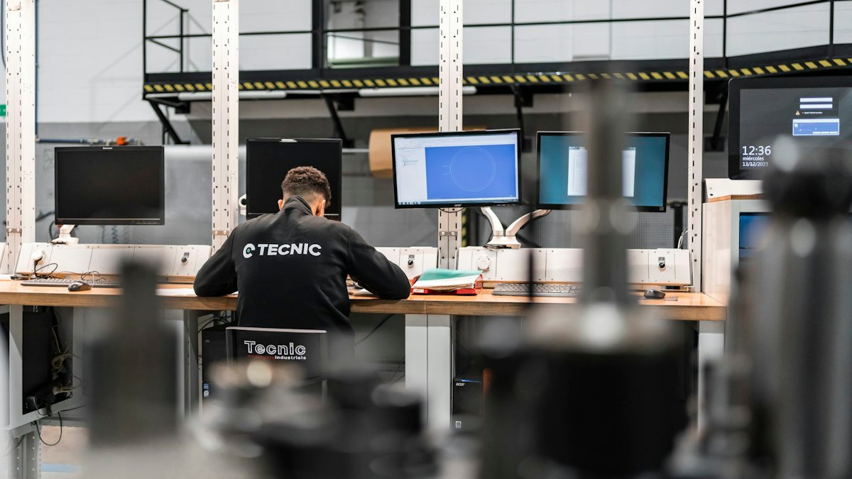 Photo by TECNIC Bioprocess Solutions on Unsplash. Source: https://unsplash.com/photos/a-worker-is-concentrating-at-multiple-computer-screens-SQkt_CJ-ARs (Unsplash License).