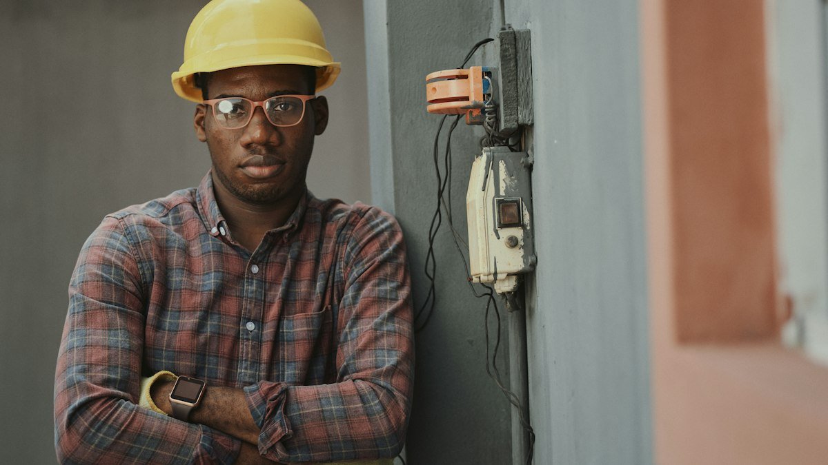 A data center buildout worker beside electrical distribution equipment