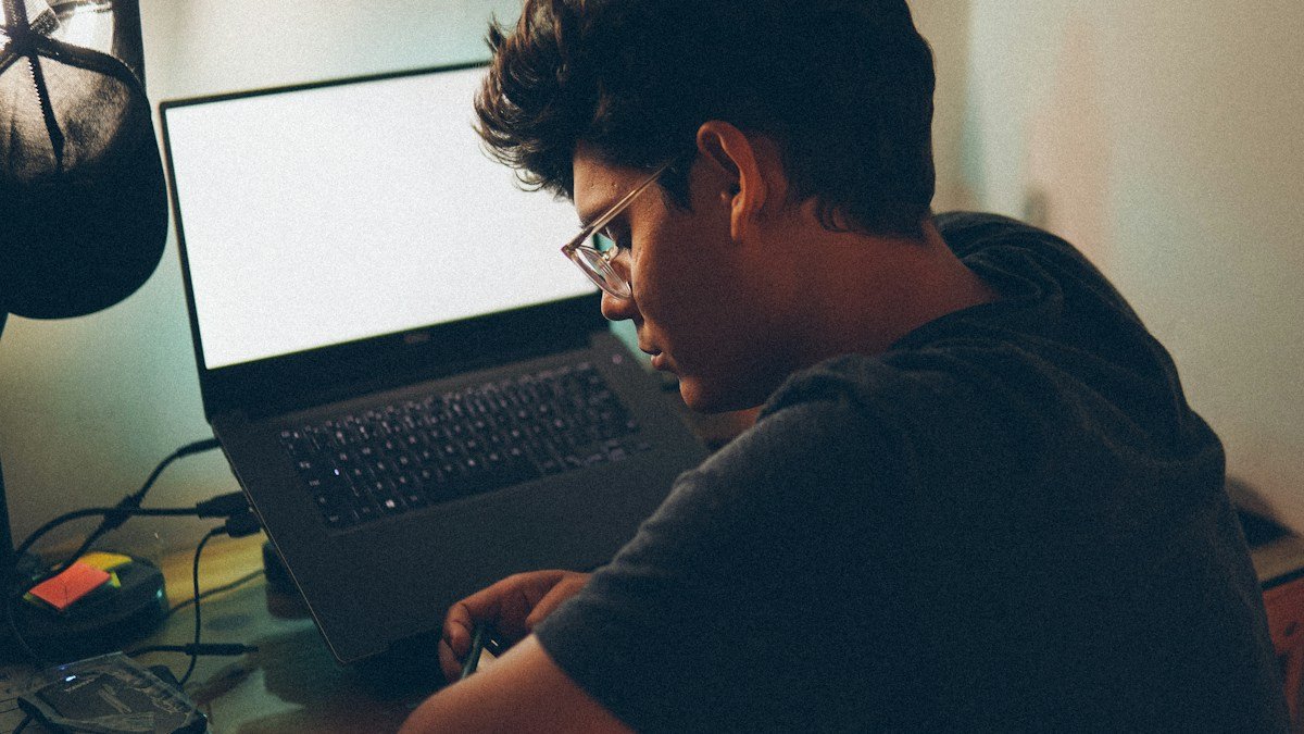 Photo by Fábio Lucas on Unsplash. Source: https://unsplash.com/photos/a-man-sitting-in-front-of-a-laptop-computer-YXFvNxrgNAg (Unsplash License).
