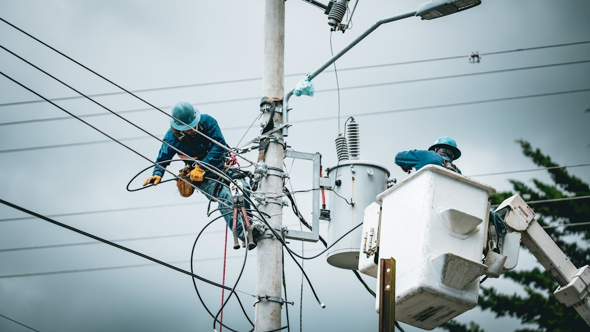 Photo by Mario Spencer on Unsplash. Source: https://unsplash.com/photos/linemen-working-on-a-utility-pole-with-bucket-truck-UyqxlMS8X84 (Unsplash License).