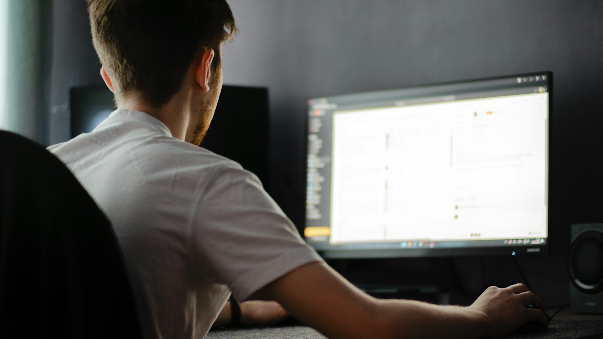 Photo by Vadim Bogulov on Unsplash. Source: https://unsplash.com/photos/a-man-sitting-in-front-of-a-computer-monitor-HvuFQUUj7ys (Unsplash License).
