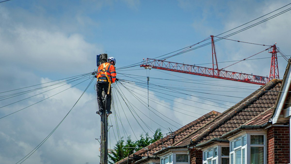 Photo by Ed Wingate on Unsplash. Source: https://unsplash.com/photos/a-lineman-works-on-power-lines-mRVsNxlhtwA (Unsplash License).