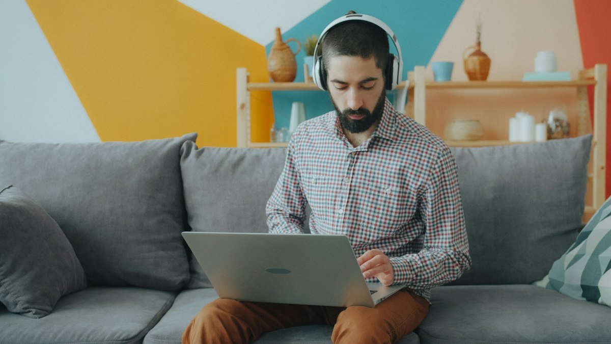 Photo by Vitaly Gariev on Unsplash. Source: https://unsplash.com/photos/man-using-laptop-on-sofa-AYAuwXLE7Ag (Unsplash License).