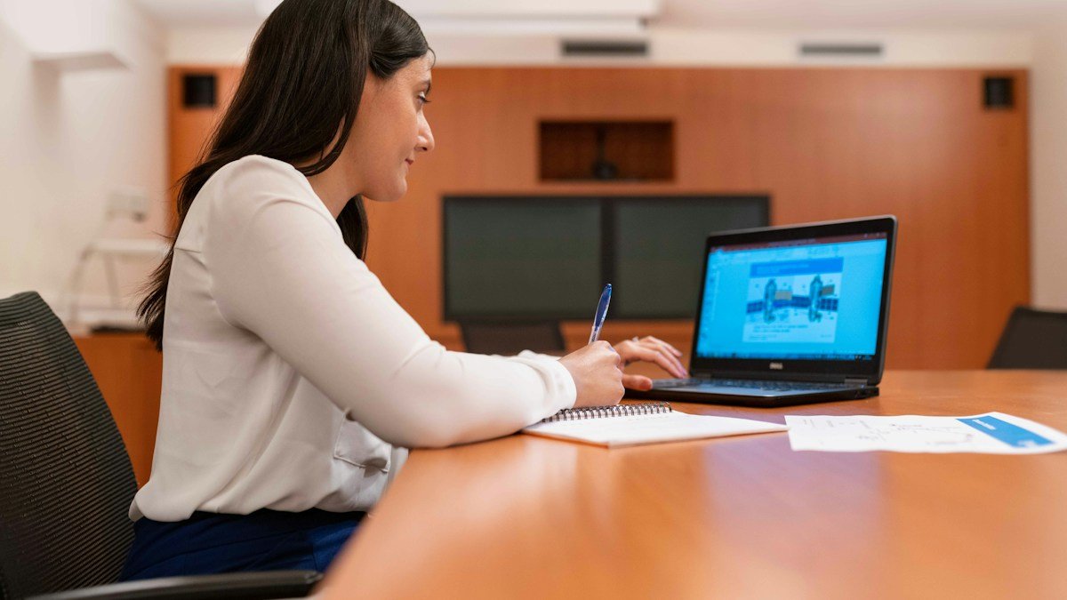 A person with a laptop reviews technical diagrams at a desk. Photo by ThisisEngineering on Unsplash. Source: https://unsplash.com/photos/woman-in-white-long-sleeve-shirt-using-black-laptop-computer-1dwyU46p7eE (Unsplash License).