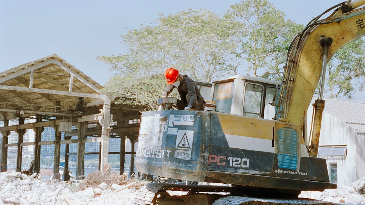 Photo by Zhen Yao on Unsplash. Source: https://unsplash.com/photos/worker-in-hard-hat-on-excavator-near-excavator-8RN3mZ852Pw (Unsplash License).