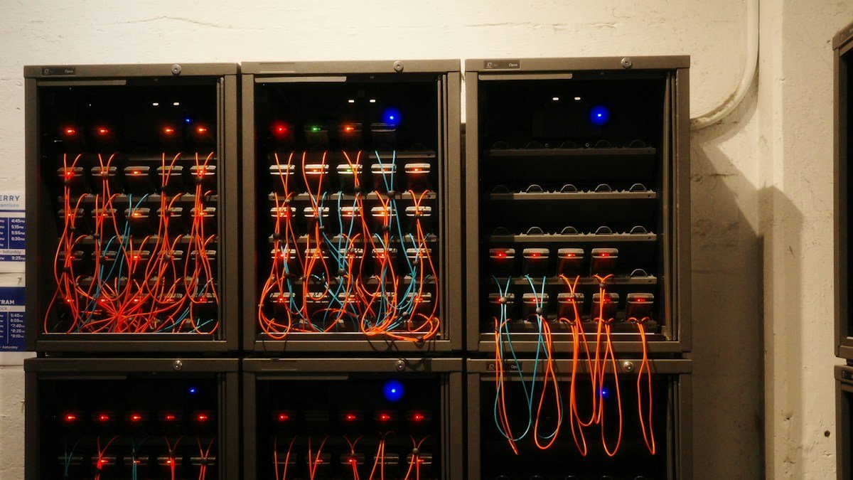 Photo by Fabio Sasso on Unsplash. Source: https://unsplash.com/photos/network-servers-are-connected-with-cables-3qZ6qT1DKxU (Unsplash License).