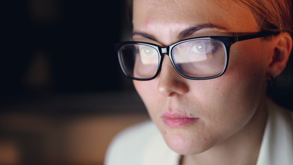 Photo by Vitaly Gariev on Unsplash. Source: https://unsplash.com/photos/woman-wearing-glasses-looking-intently-at-screen-AAJjYPEsRCY (Unsplash License).