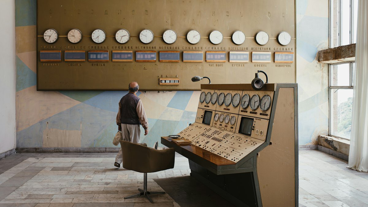 Photo by Yuri Krupenin on Unsplash. Source: https://unsplash.com/photos/a-man-standing-in-front-of-a-control-panel-iK0ODqrNlvE (Unsplash License).