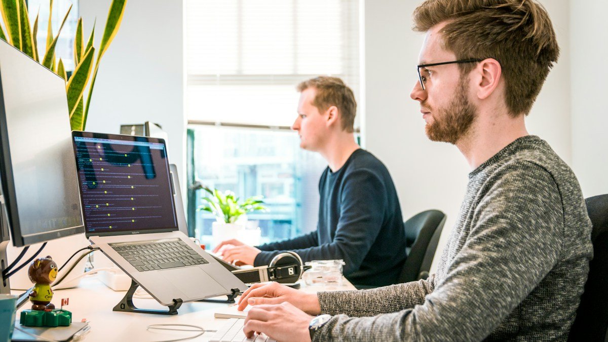 Photo by Tim van der Kuip on Unsplash. Source: https://unsplash.com/photos/man-sitting-on-chair-wearing-gray-crew-neck-long-sleeved-shirt-using-apple-magic-keyboard-CPs2X8JYmS8 (Unsplash License).