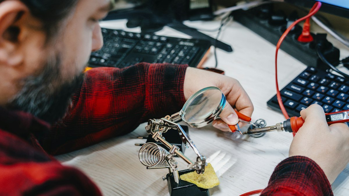 Photo by Yuriy Vertikov on Unsplash. Source: https://unsplash.com/photos/a-man-sitting-at-a-desk-working-on-a-computer-gOw5-yI5sS8 (Unsplash License).