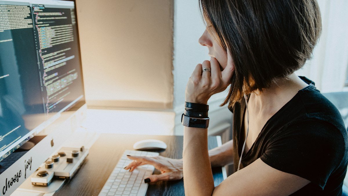 Photo by Kelly Sikkema on Unsplash. Source: https://unsplash.com/photos/woman-wearing-black-t-shirt-holding-white-computer-keyboard-YK0HPwWDJ1I (Unsplash License).