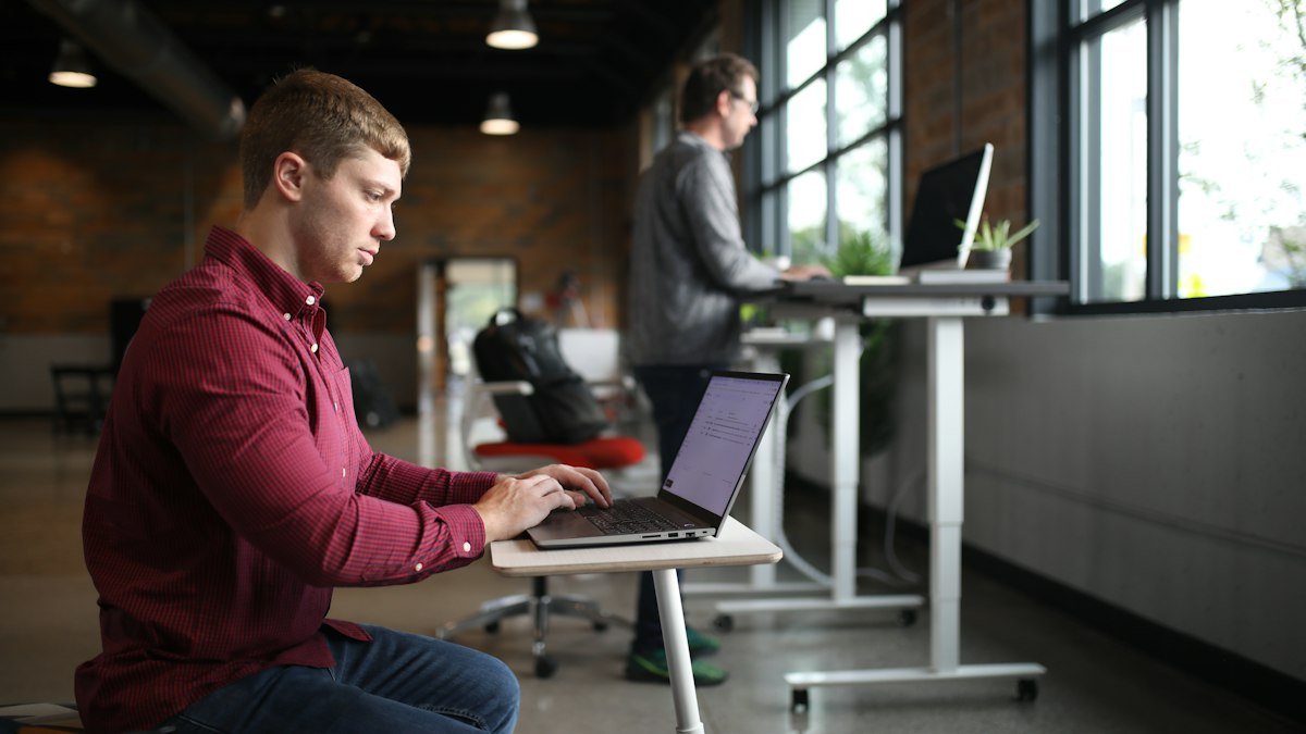 Photo by TheStandingDesk on Unsplash. Source: https://unsplash.com/photos/a-man-sitting-at-a-desk-using-a-laptop-computer-TOQbJ7VpUkU (Unsplash License).