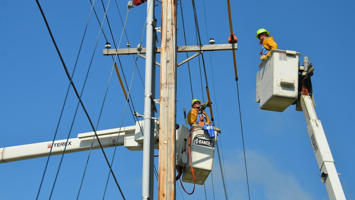 Photo by American Public Power Association on Unsplash. Source: https://unsplash.com/photos/two-linemen-on-cherry-pickers-fHLdXfURDhA (Unsplash License).