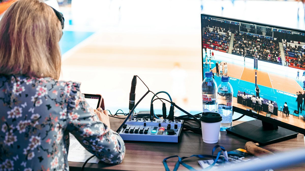 Photo by daniil kazorin on Unsplash. Source: https://unsplash.com/photos/woman-monitoring-volleyball-match-at-desk-rZWP7ieeISg (Unsplash License).