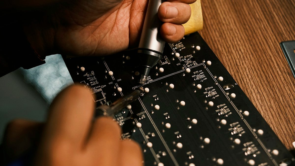 Photo by Minh Đức on Unsplash. Source: https://unsplash.com/photos/a-person-is-working-on-a-circuit-board-K0dKbS9_aC8 (Unsplash License).