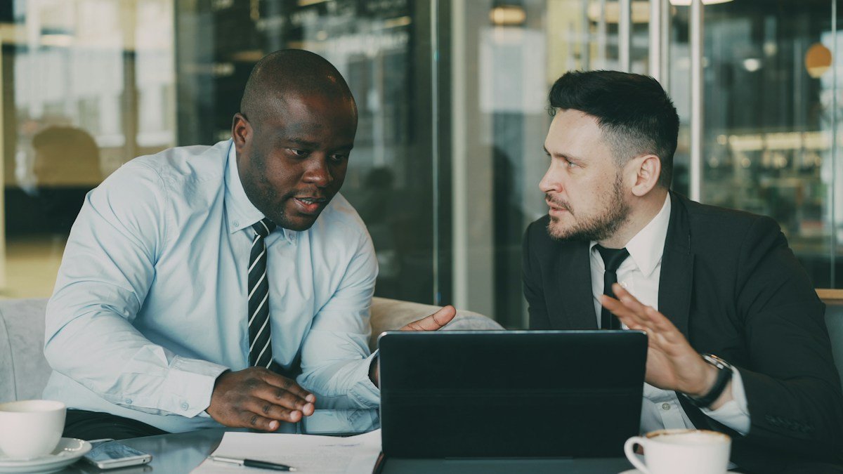 Photo by Vitaly Gariev on Unsplash. Source: https://unsplash.com/photos/two-businessmen-collaborating-over-a-tablet-and-laptop-qlLIFT8cceo (Unsplash License).