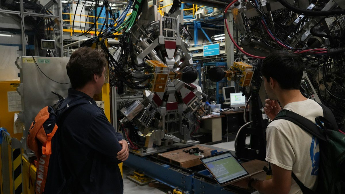 Photo by Daniel Miksha on Unsplash. Source: https://unsplash.com/photos/two-men-observe-complex-scientific-machinery-in-a-laboratory--6RHGcAhAHc (Unsplash License).