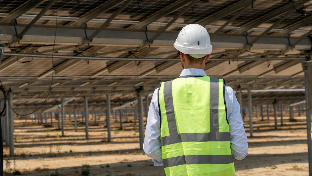 Photo by Sikwe Scarter on Unsplash. Source: https://unsplash.com/photos/a-man-wearing-a-safety-vest-and-hard-hat-hBE96YanOlM (Unsplash License).