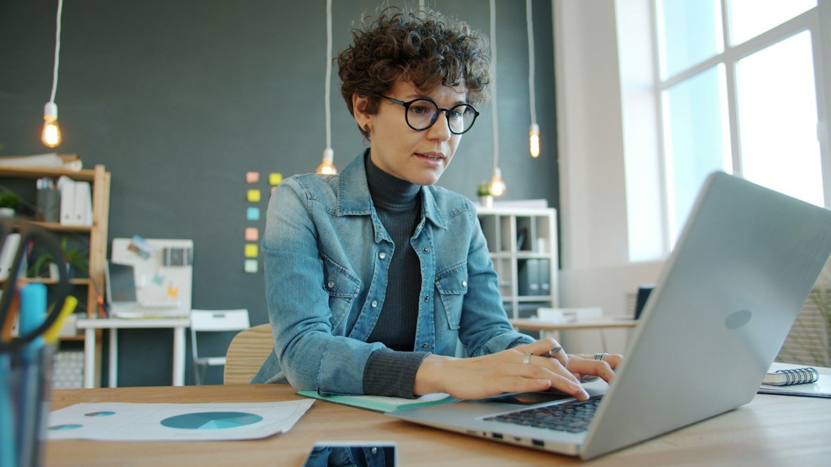 Photo by Vitaly Gariev on Unsplash. Source: https://unsplash.com/photos/woman-working-on-a-laptop-in-a-modern-office-WrlIRaC9t-A (Unsplash License).