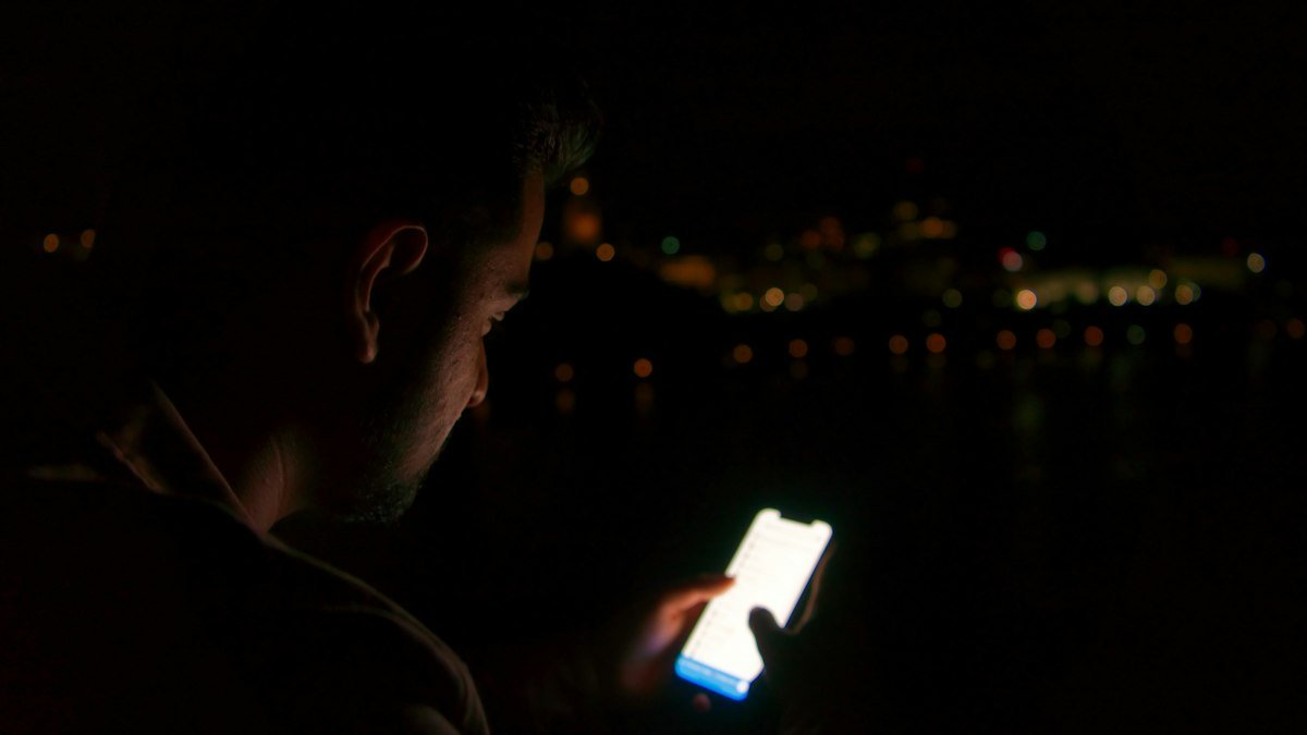 Photo by Shubham Sharan on Unsplash. Source: https://unsplash.com/photos/man-in-black-shirt-holding-white-smartphone-1rJdewJPCWE (Unsplash License).